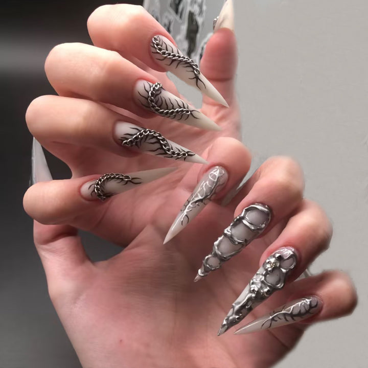 Creative nail art set with elegant floral designs and metallic accents Stornfield