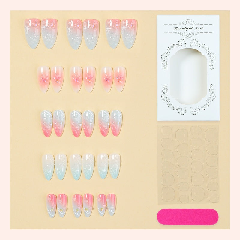 Acrylic nail set with elegant ombre design and floral decorations Stornfield