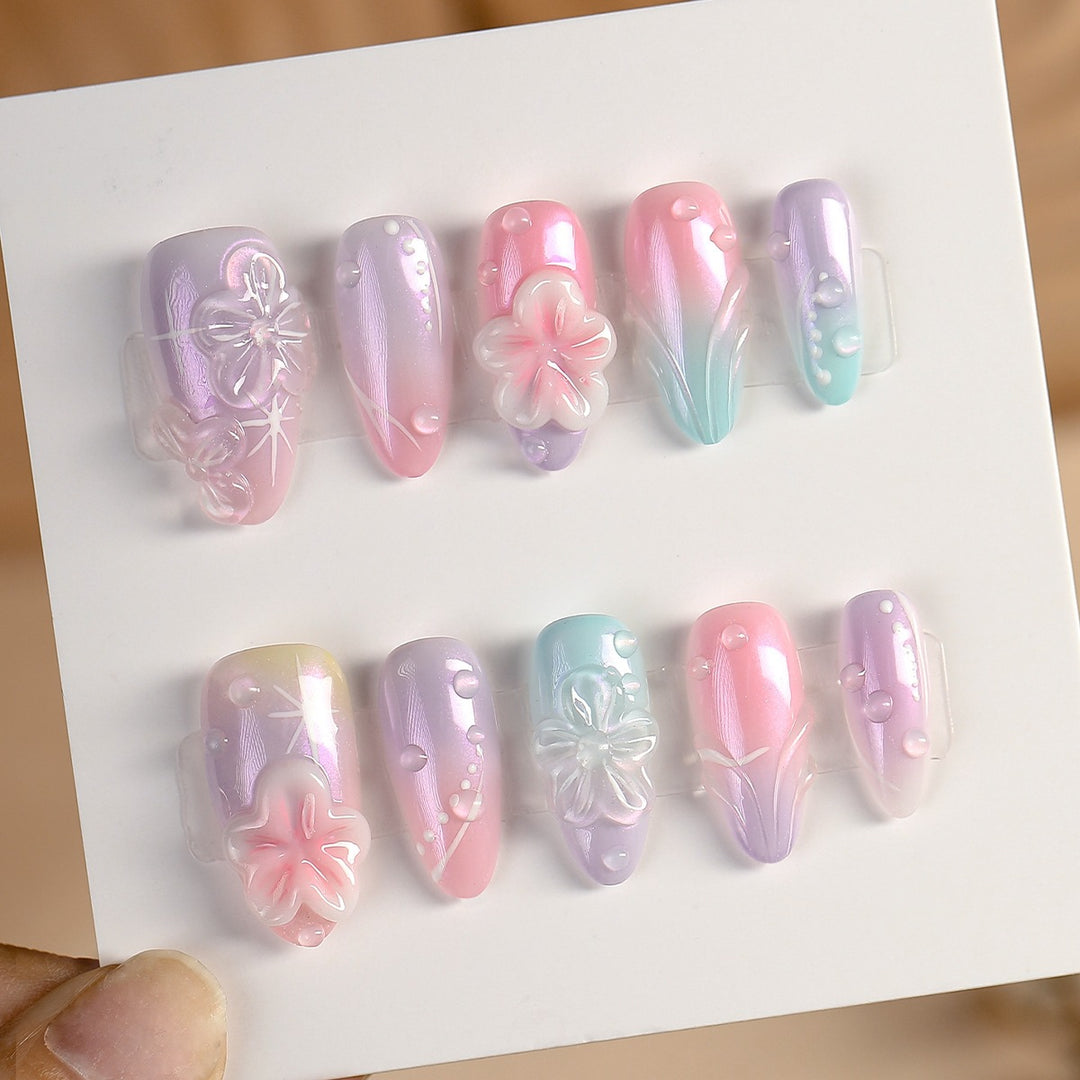 Artificial nail set with floral accents and delicate glitter effect Stornfield