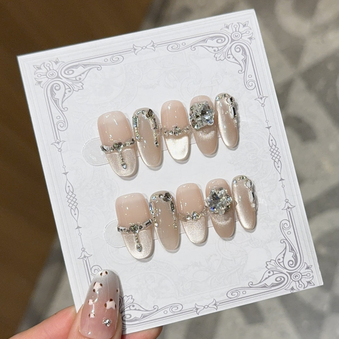 Glamorous nail tips with rhinestone and glitter effects Stornfield