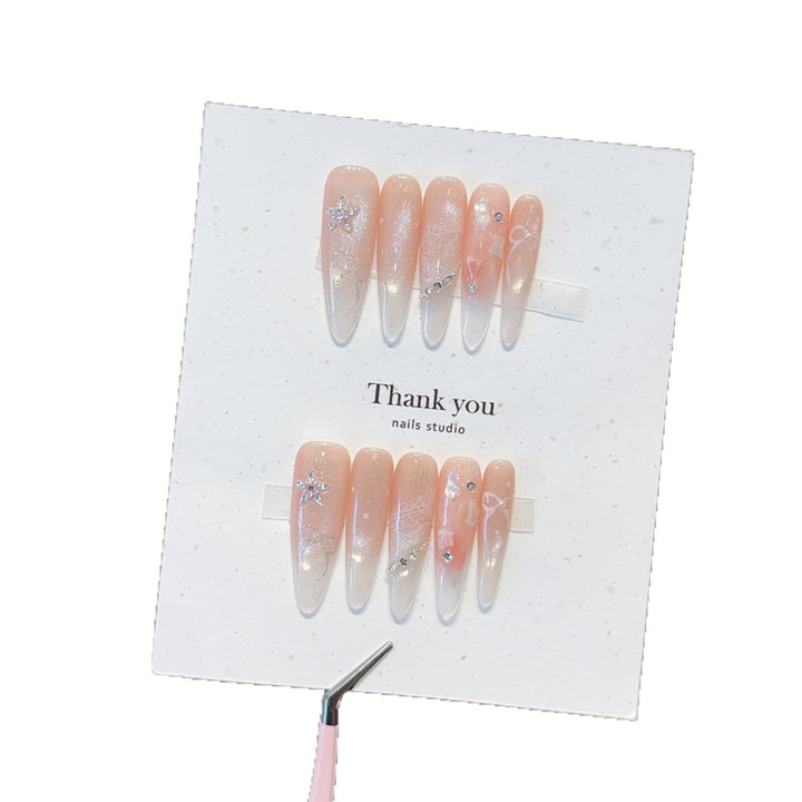 Artificial nails with filigree design and glitter accents Stornfield