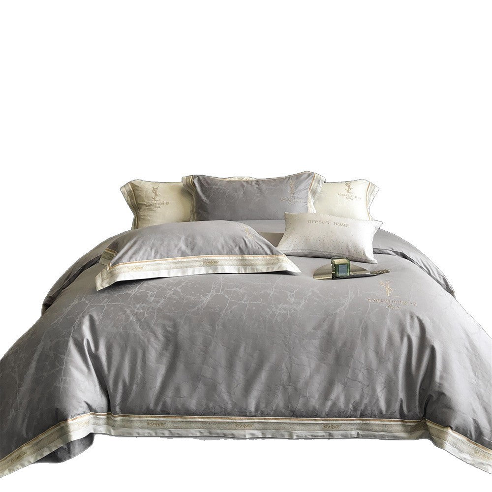 Luxurious satin bedding set with subtle marble texture and golden embroidered border