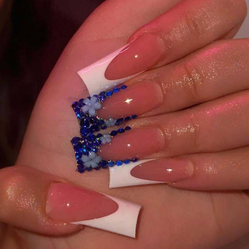 Artificial nail design with trendy blue accents and glitter coating Stornfield