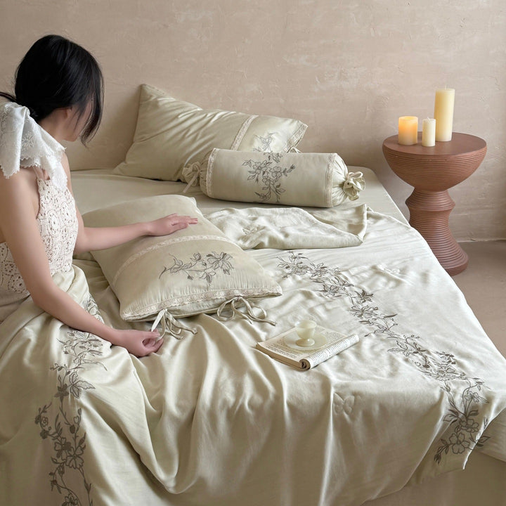 Elegant bedding set made of cotton satin with floral embroidered border and decorative roll cushion Stornfield
