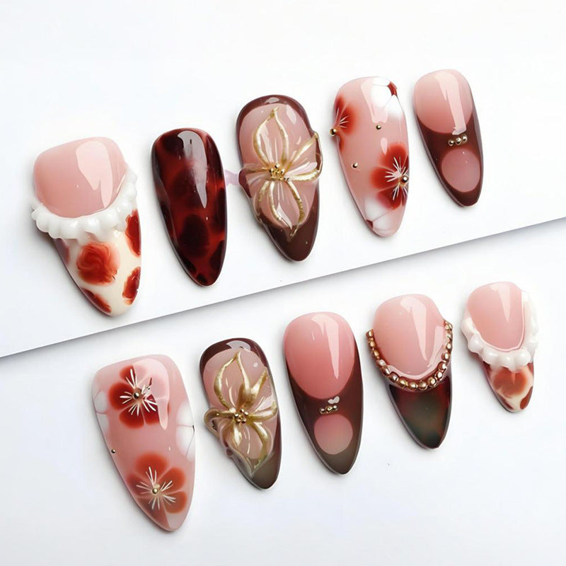 Artificial nail set with luxurious floral designs and glitter accents Stornfield