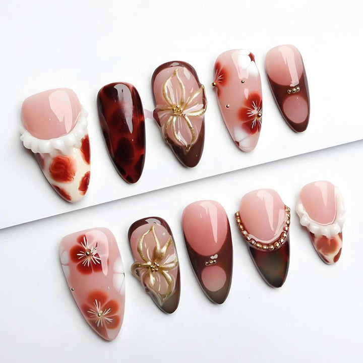 Artificial nail set with luxurious floral designs and glitter accents Stornfield