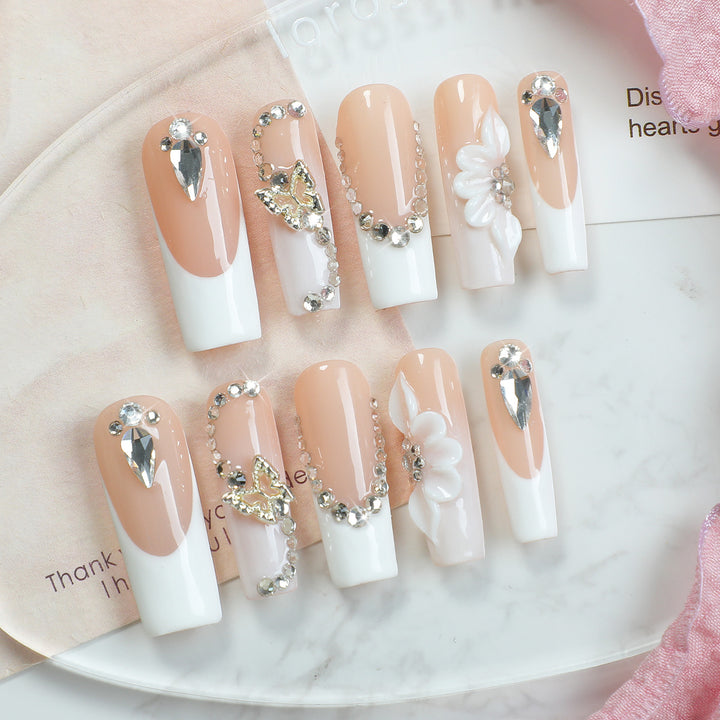 Artificial nail set with elegant glitter and flower motifs Stornfield