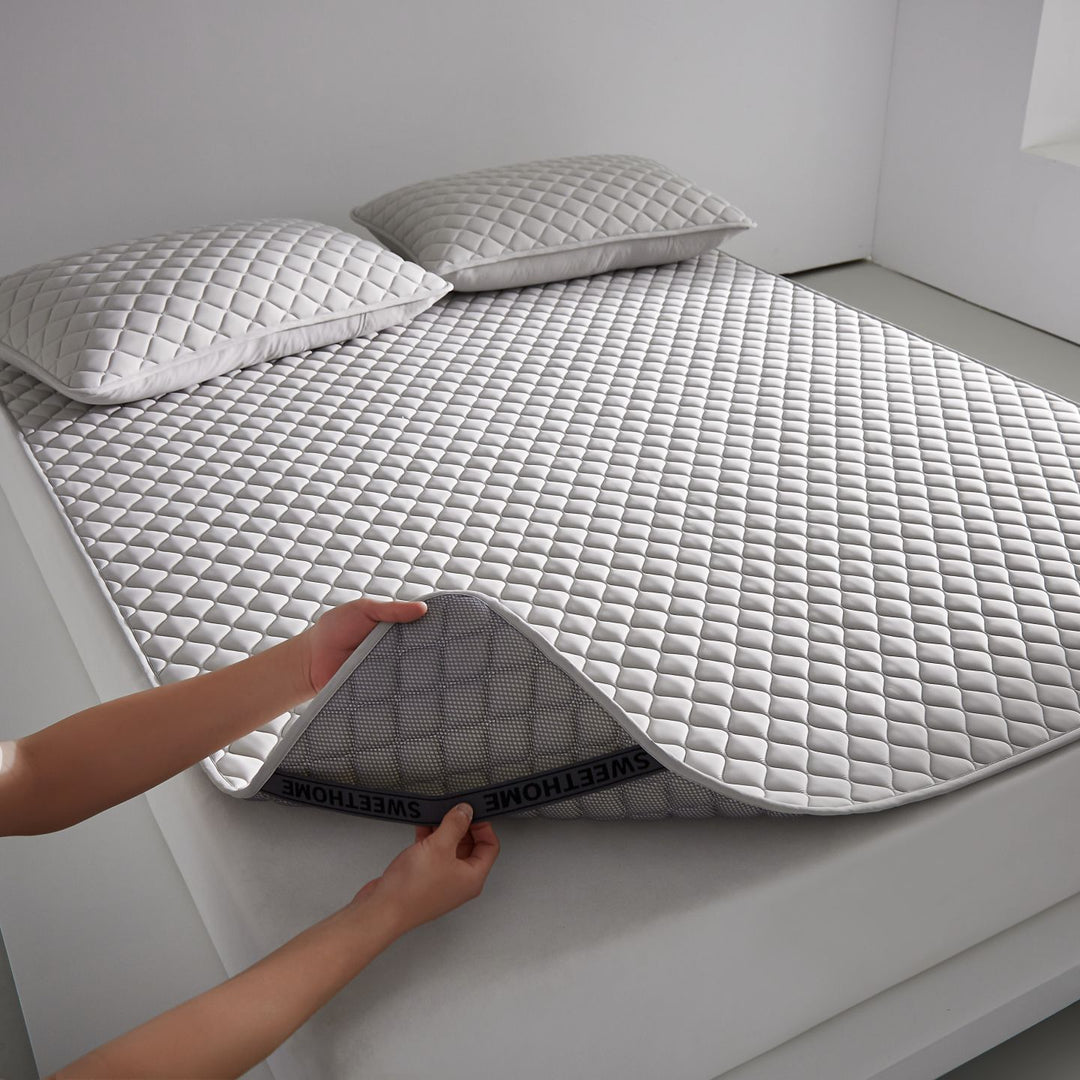Breathable cooling mattress topper with quilted surface and elastic corner bands