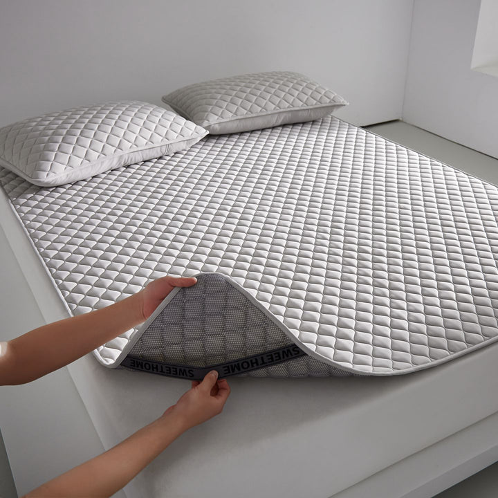 Breathable cooling mattress topper with quilted surface and elastic corner bands