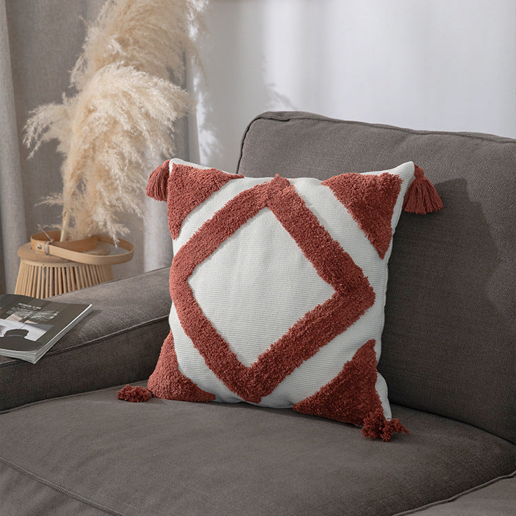 Square decorative cushion cover made of cotton bouclé with raised diamond pattern and corner tassels