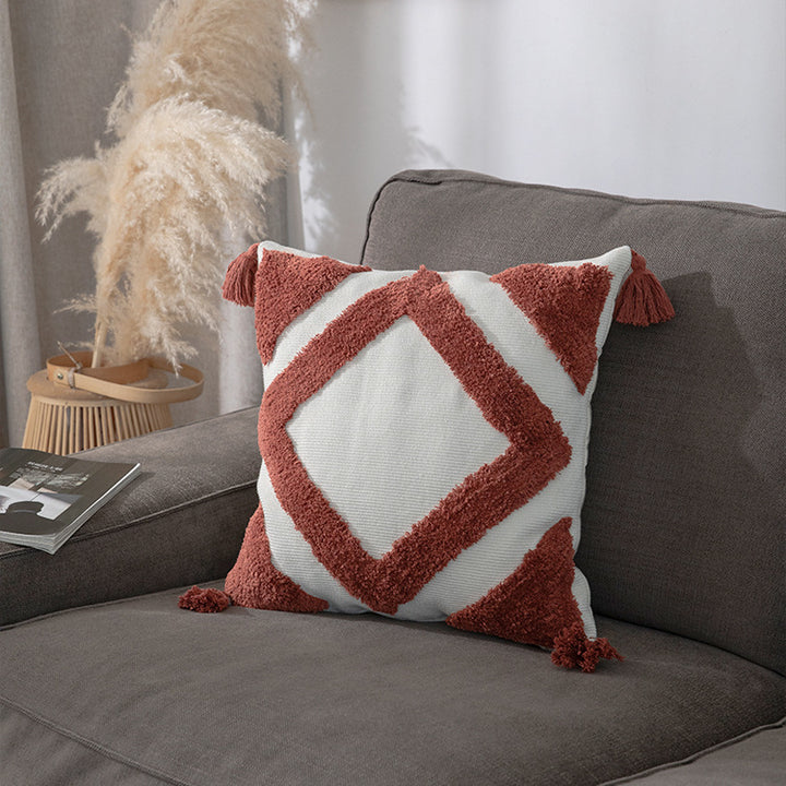 Square decorative cushion cover made of cotton bouclé with raised diamond pattern and corner tassels