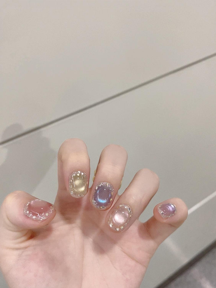 Artificial acrylic nails with shimmering effects and elegant glitter accents Stornfield