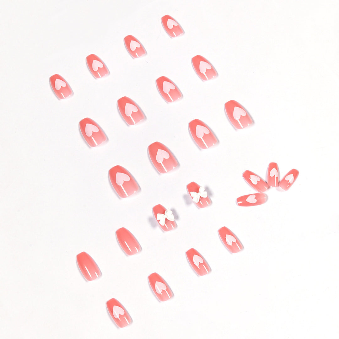 Artistic acrylic nails with heart and bow motifs Stornfield