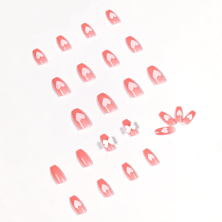Artistic acrylic nails with heart and bow motifs Stornfield