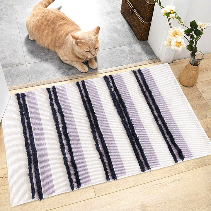 Rectangular flat-woven cotton rug with raised tufted stripes