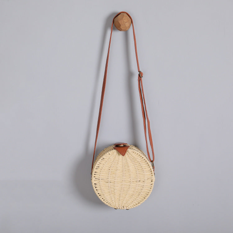 Round basket bag with leather accents Stornfield