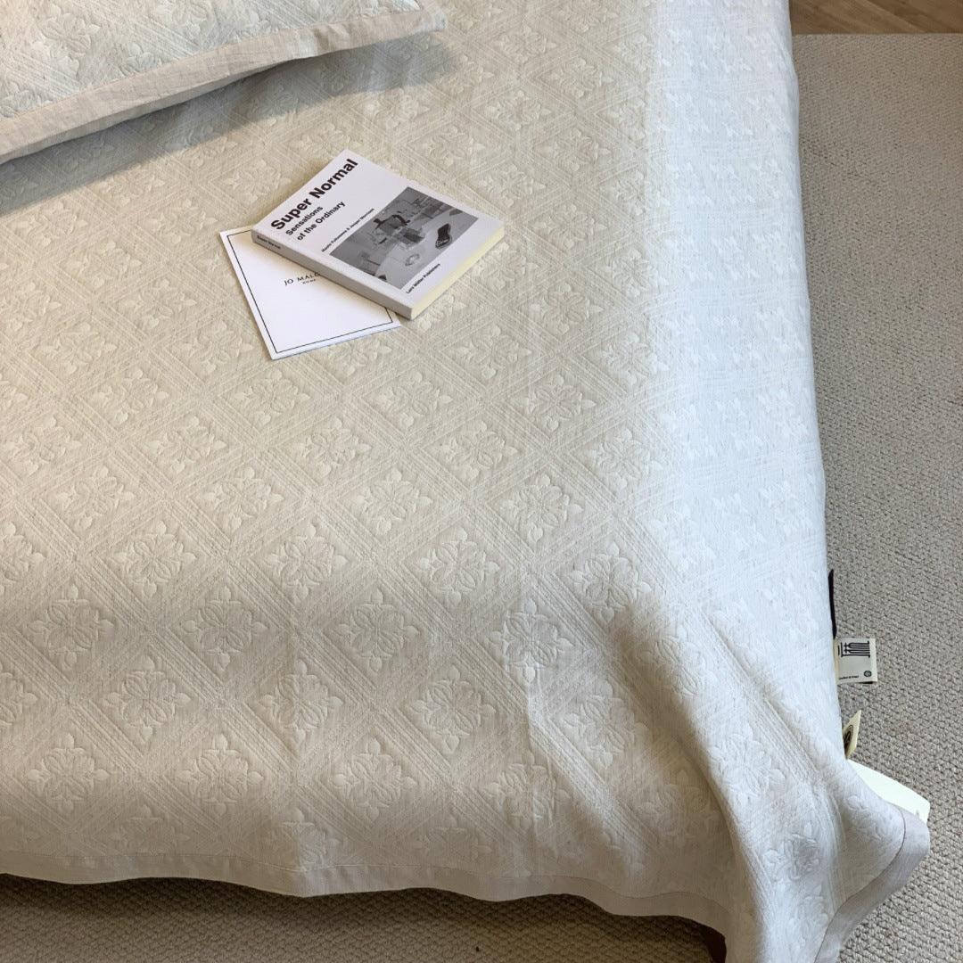 Jacquard cushion cover with quilted diamond pattern and piping