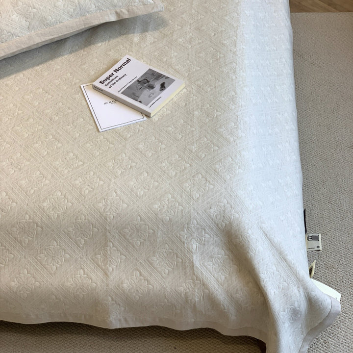 Jacquard cushion cover with quilted diamond pattern and piping