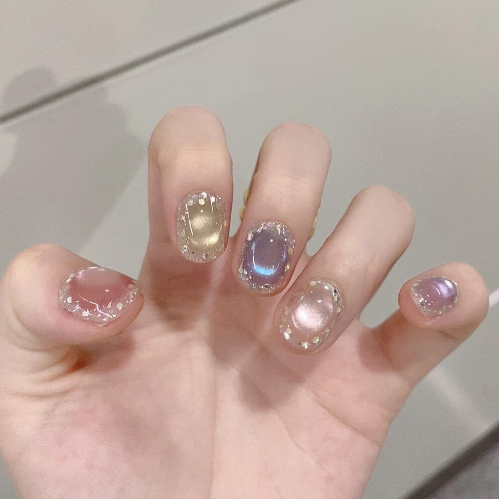 Artificial acrylic nails with shimmering effects and elegant glitter accents Stornfield