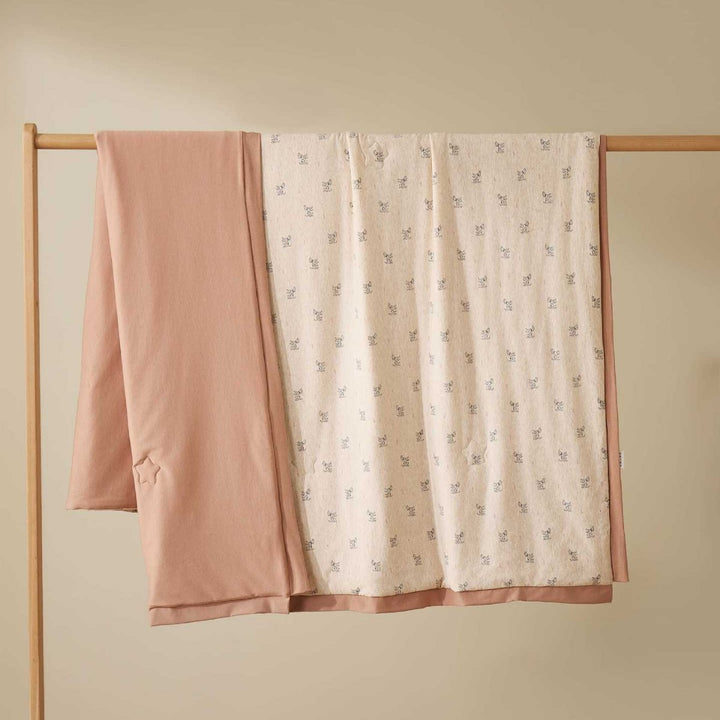 Double-layer baby crawling blanket made of cotton jersey with light padding and delicate all-over animal print
