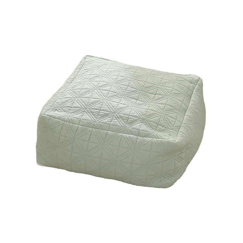 Padded footstool pouf with quilted cover fabric and shape-stable core