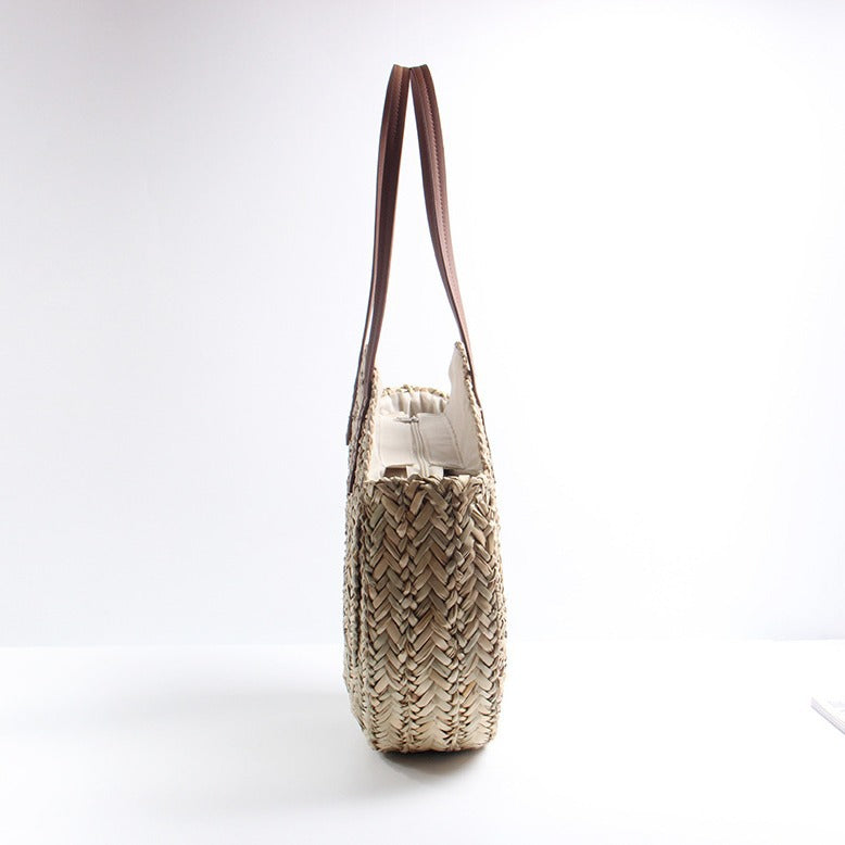 Braided straw beach bag with elegant leather handles Stornfield