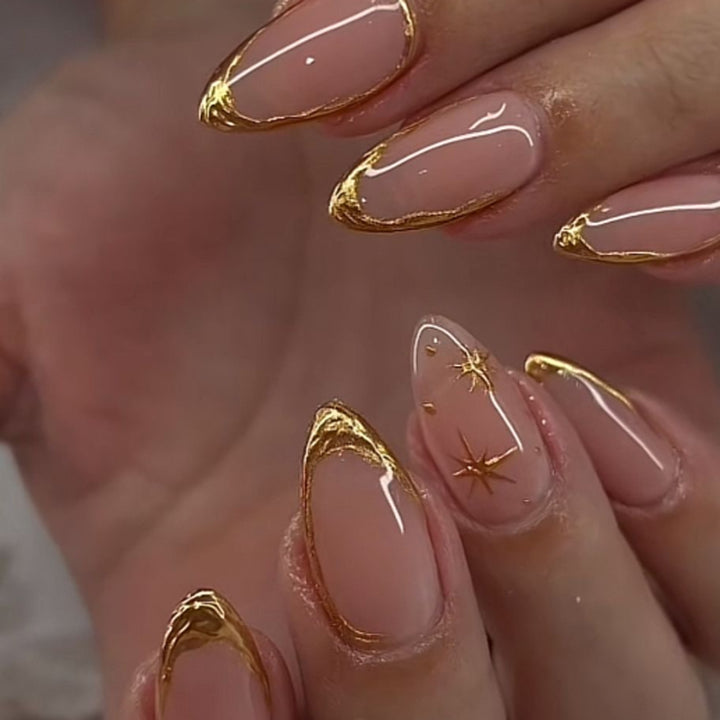 Glamorous stiletto nails with golden accents Stornfield
