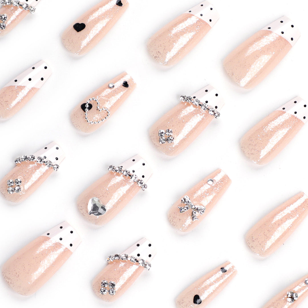 Artful nail extensions with elegant rhinestone and heart designs Stornfield