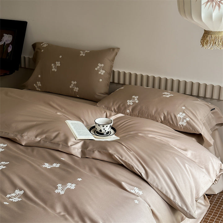 Elegant satin bed linen set with subtle floral embroidery and silk-like sheen