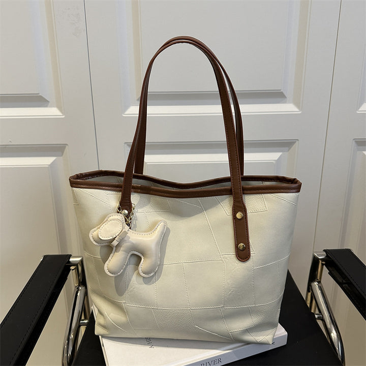 Stylish Textured Tote Bag with Decorative Charm