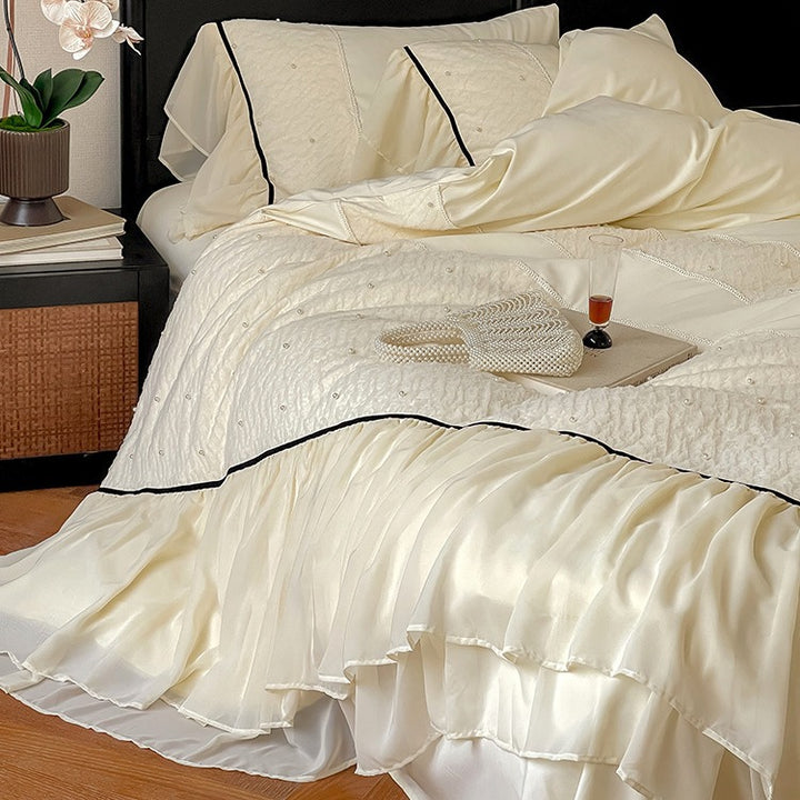 Luxurious bedding set with chiffon ruffles, comforter and contrast piping