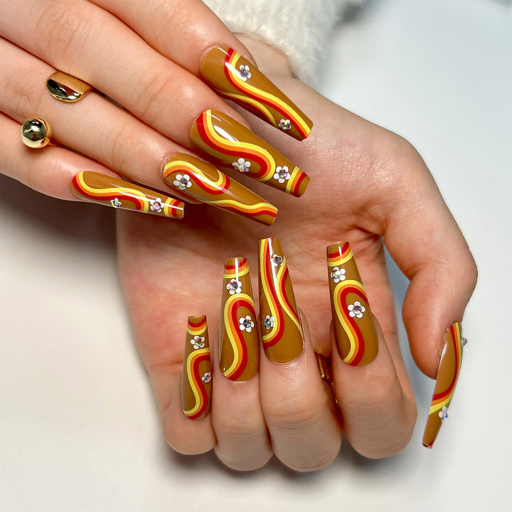 Artful acrylic nails with wave design and floral embellishments Stornfield