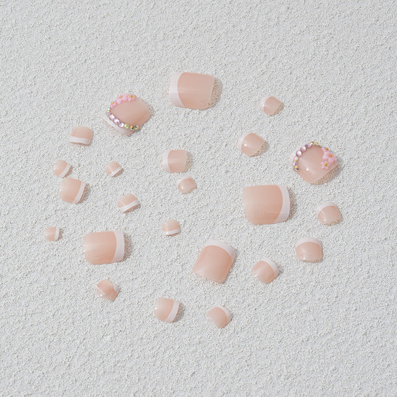 Elegant toenail art with delicate 3D floral decorations Stornfield
