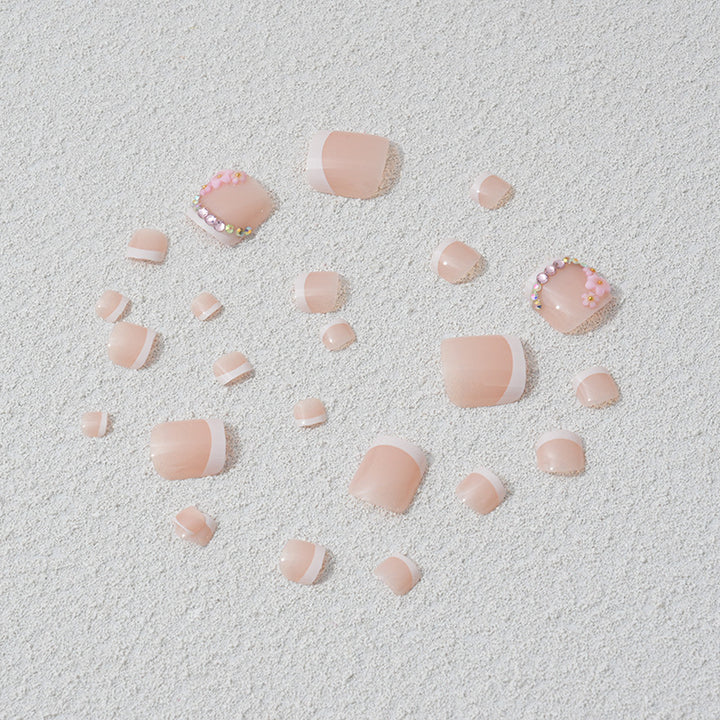 Elegant toenail art with delicate 3D floral decorations Stornfield