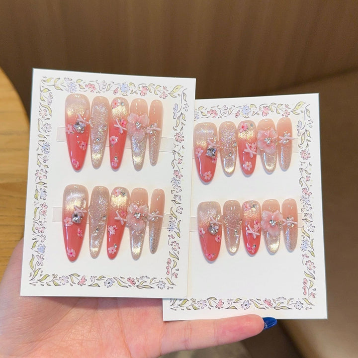 Artificial nails with floral embellishments and glitter effects Stornfield