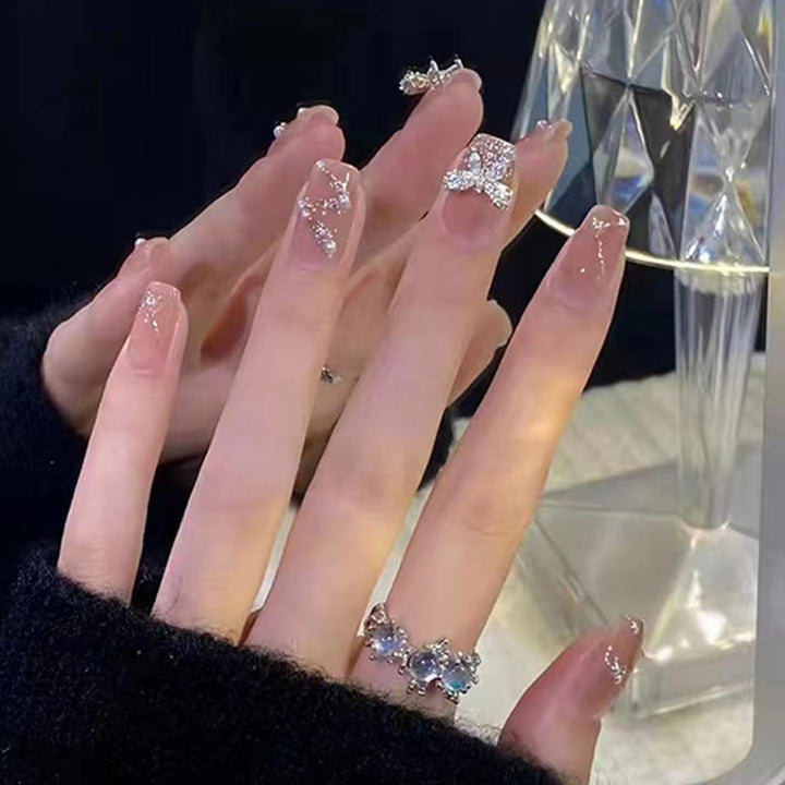 Artificial nails in an elegant design with 3D butterflies and glitter accents Stornfield