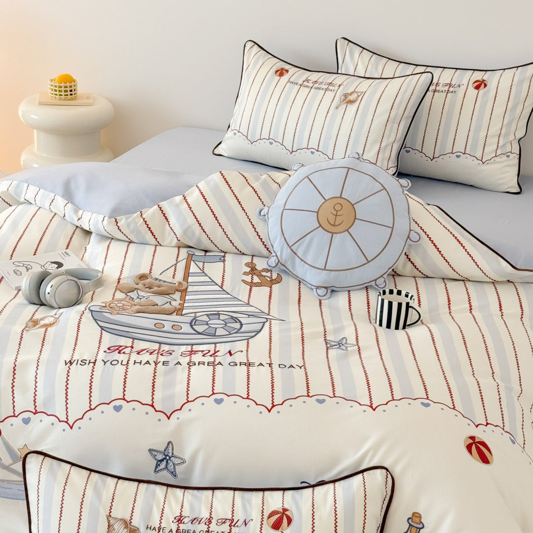 Children's bedding set with embroidered comic design and striped details