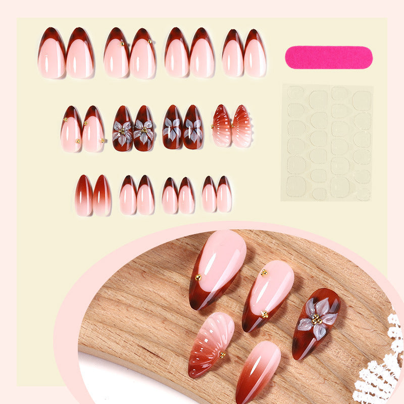 Nail art set with detailed ombre design and creative flower accents Stornfield