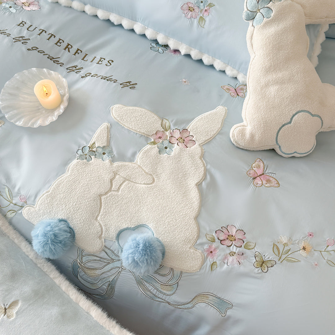 Playful cotton satin bedding set with appliquéd bunny pom-pom trim and floral embroidery