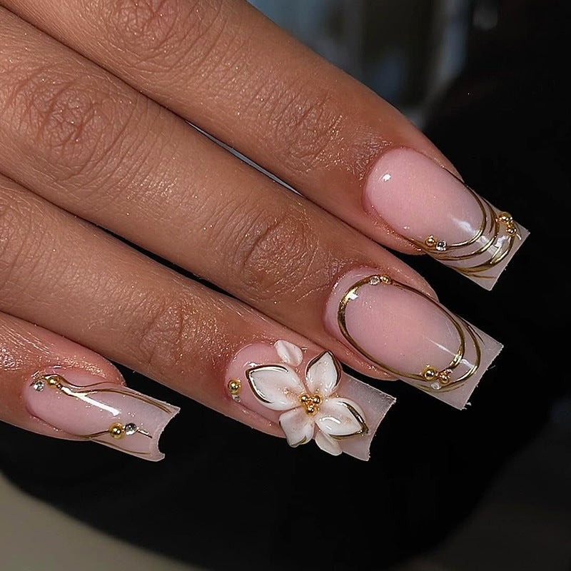 Elegant artificial nail set with decorative flower and gold embellishments Stornfield