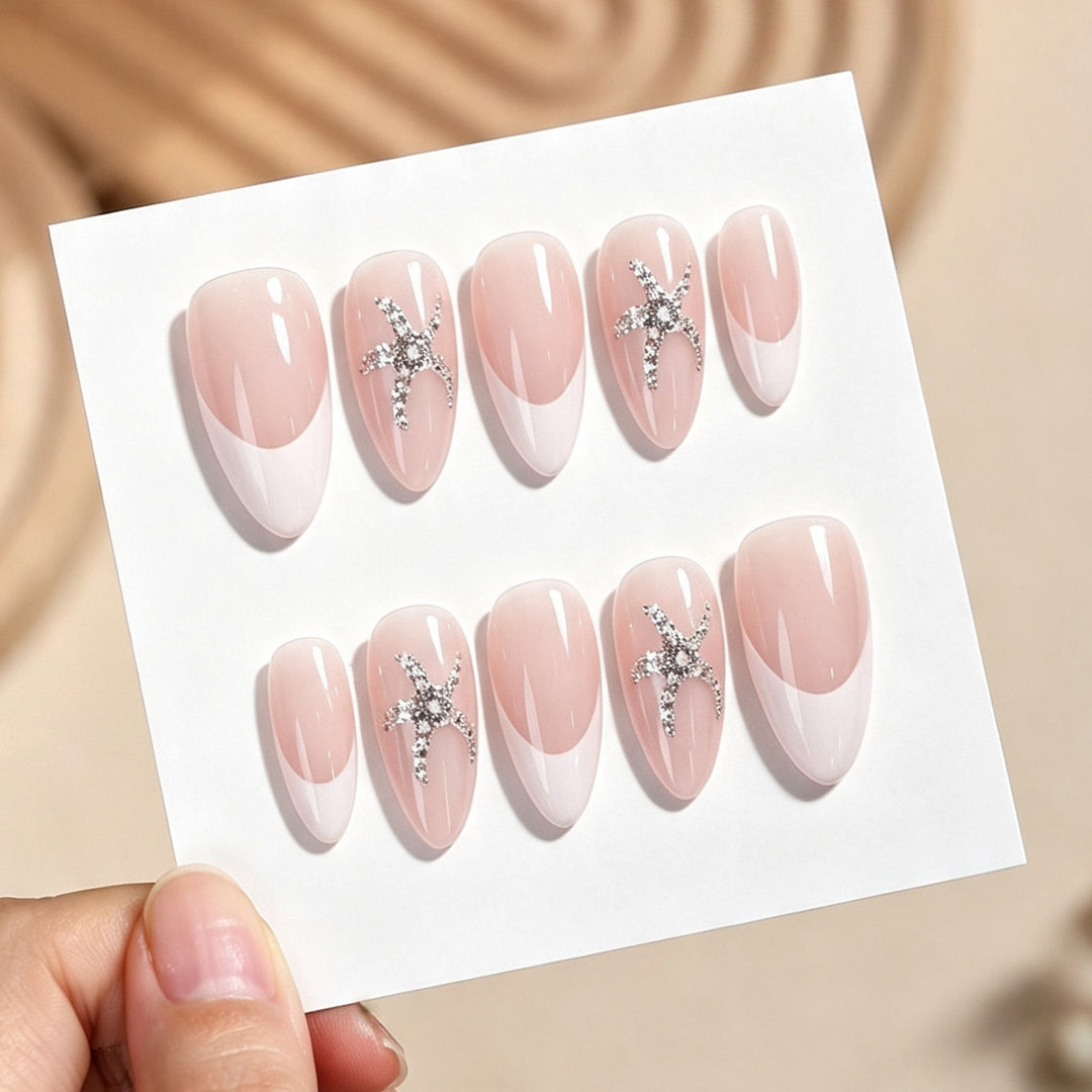 Artificial nail set with delicate pearlescent and glitter accents Stornfield