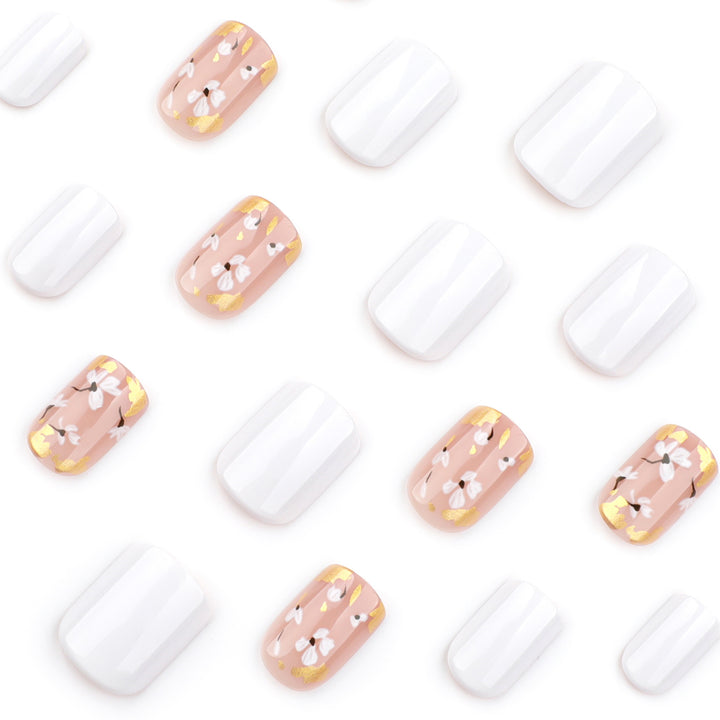 Artificial nail art with delicate flowers and glitter accents Stornfield
