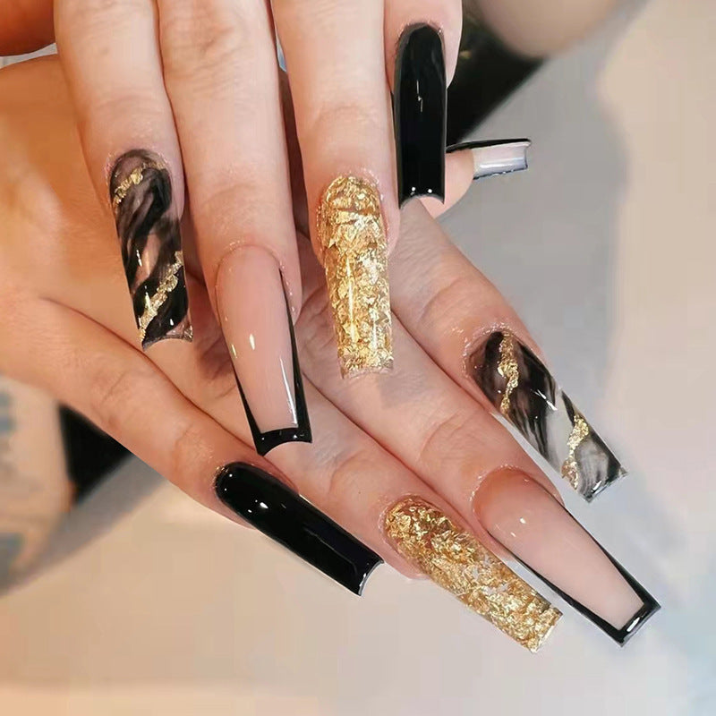 Acrylic nail set with luxurious golden accents and elegant designs Stornfield