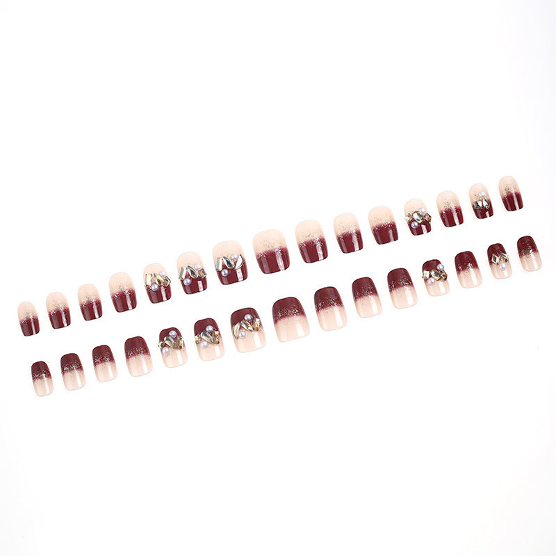 Glamorous artificial nails with decorative pearl and glitter embellishments Stornfield