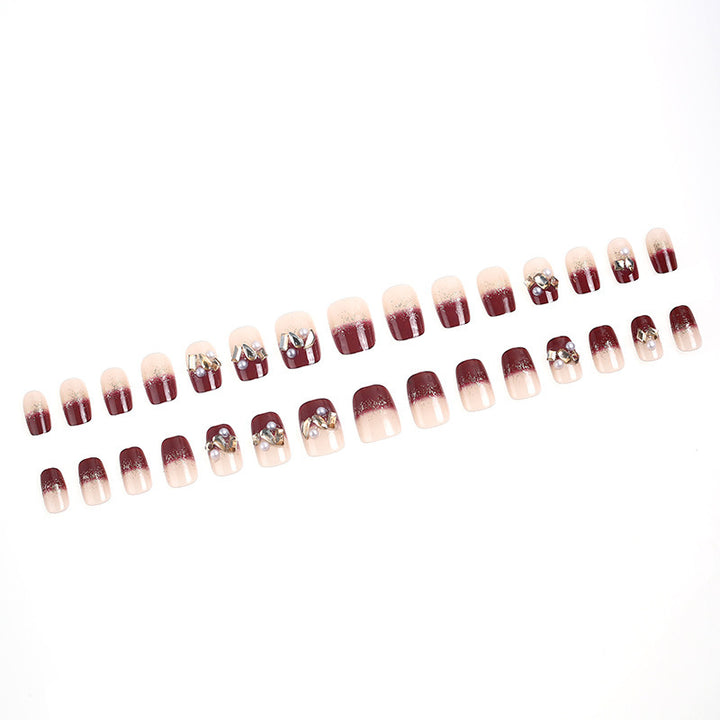 Glamorous artificial nails with decorative pearl and glitter embellishments Stornfield