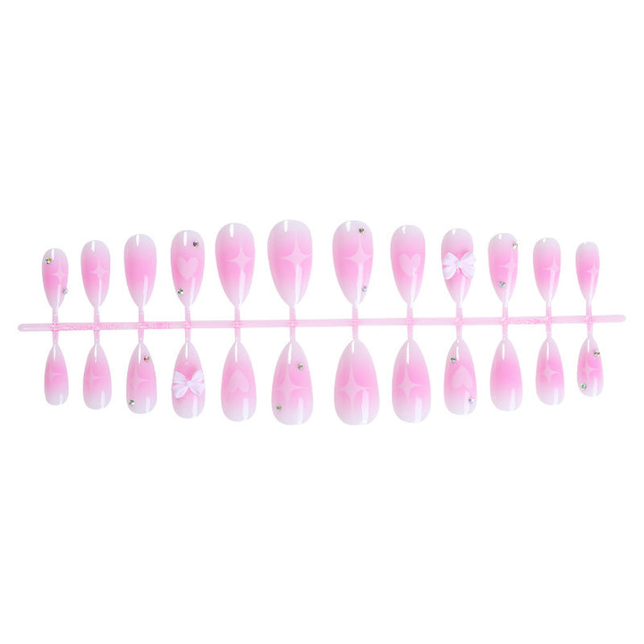 Acrylic nail set with delicate heart-shaped accents Stornfield