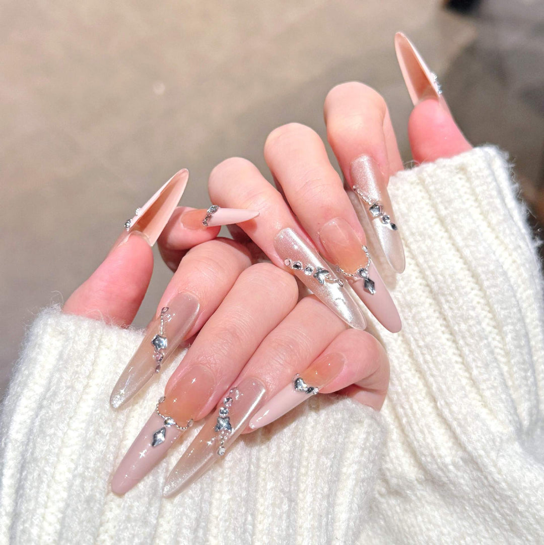 Artistic Stiletto Press-On Nail Art with Glimmering Accents Stornfield