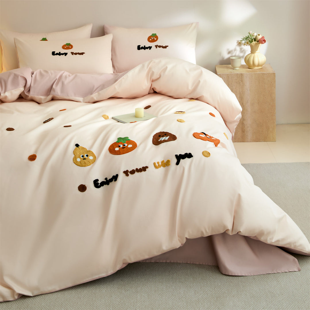 Embroidered bedding set with cute pumpkin appliqués and reversible functionality
