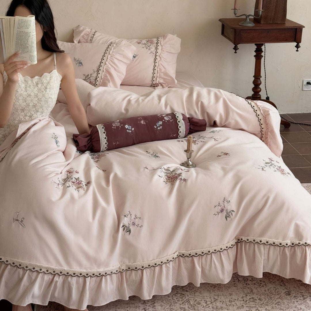 Romantic bedding set with ruffle, floral embroidery and decorative roll