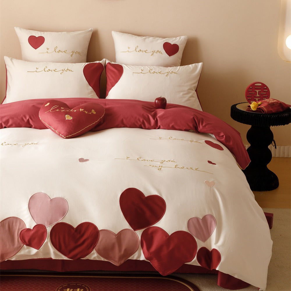 Romantic bedding set made of cotton satin with appliquéd hearts and golden embroidery